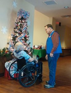 Roger talks with one of the veteran residents during the annual holiday party.